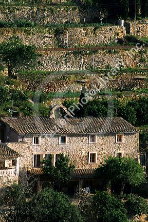 A home and stone wall terraces at Banyalbufar, Majorca, Spain.