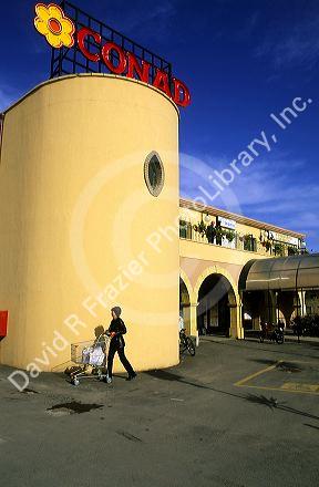 A customer pushes a shopping cart outside of a super market in Sardinia, Italy.