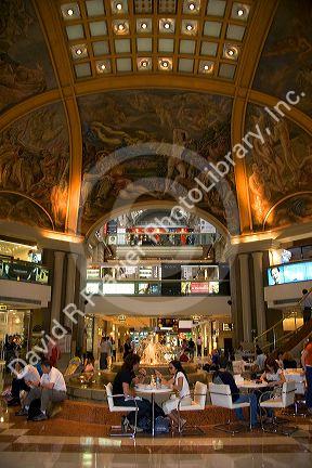 Fresco paintings adorn the ceiling of Galeria Pacifico and cafe seating in Buenos Aires, Argentina.