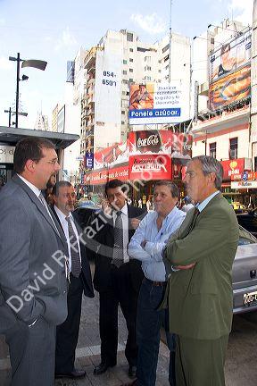Business men talk on the street in Buenos Aires, Argentina.