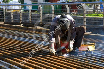 Construction worker welding on a bridge deck in Buenos Aires, Argentina.