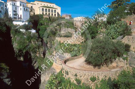 Buildings and walkways on the edge of the gorge in Ronda, Spain.