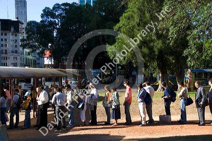 Passengers waiting in line to get on the bus in Buenos Aires, Argentina.