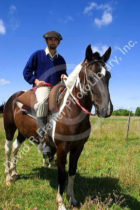 Gaucho riding a horse near Neccochea, Argentina.