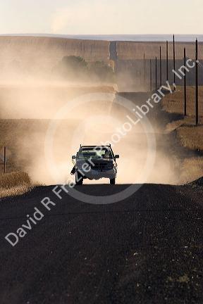 Pick up truck on dusty rural road near Pendleton, Oregon.