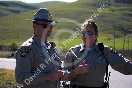 Male and female California highway patrol officers.