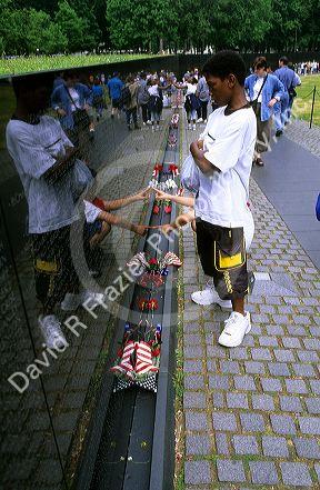 African american boy visits the Vietnam War Memorial in Washington DC.
