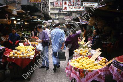 People shop at a traditional produce market in Hong Kong.