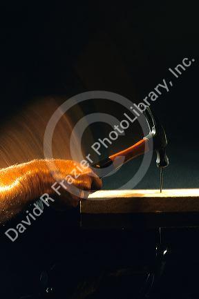 A hammer hitting a nail.