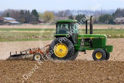 Tractor spring tilling the soil in Twin Falls County, Idaho.