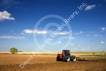 A tractor spring tilling a crop in Canyon County, Idaho.