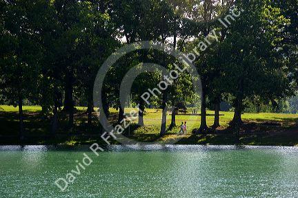 Women walking along the shore of Mammoth  Springs at the town of Mammoth Springs, Arkansas.