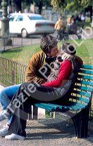 Young lovers kissing on park bench at Verona, Italy.