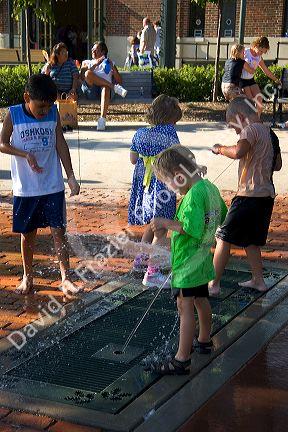 Children play in a fountain at the Iowa state fair in Des Moines.