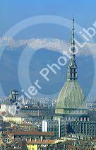 Turin, Italy and the tower of the Mole with the snow capped peaks of the Dolomites.