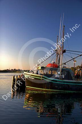 Fishing boat at sunset docked at Yarmouth, Nova Scotia, Canada.