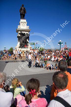 Street performers in front of a statue of Samuel Champlain in Quebec City, Quebec, Canada.