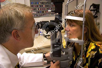 Ophthalmologist looks at patients eyes in the Mason Eye Institute at the University of Missouri - Columbia.