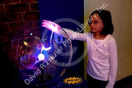 Girl touching a Plasma Ball at Union Station Science City in Kansas City, Missouri.