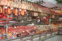Hams hang in butcher shop in Madrid Spain.