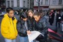 Multi racial college students looking at a map in Paris, France.