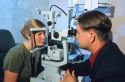 Optomitrist giving an eye exam.