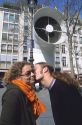 French couple greeting with a kiss.
