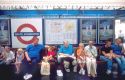 People waiting on station platform of London, England underground station at South Kensington.