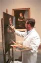 Artist painting a copy in the Prado art museum in Madrid, Spain.