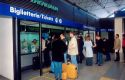Passengers line up to purchase tickets at the Rome airport train station in Italy.