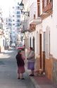 Women talking on the street in Nerja, Spain.