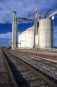 Grain elevators with a train and railroad tracks in Hinton, Iowa.