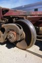 An iron wheel on a railroad car.