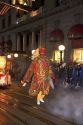 Chinese giant marches in the Chinese New Year Parade, San Francisco, California as firecrackers explode.
