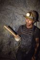 Miner holding a stick of dynamite in a silver mine at Wallace, Idaho.