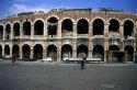 A man rides a bicycle in front of the Amphitheater in Verona, Italy.