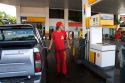 Worker pumping gas at a gas station in Argentina.