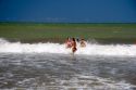 Girls play in the surf at Gesell, Argentina.