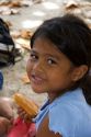 A young Tahitian girl having lunch on the island of Moorea.