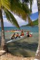 Tahitians participate in an outrigger canoe pirogue race on the island of Moorea.
