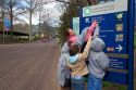 Children read a sign at the entrance to the Smithsonian National Zoologicacl Park in Washington, D.C.