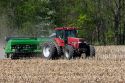 Tractor using the practice of minimum tillage for planting soy beans over last years corn crop near Clarksville, Michigan.