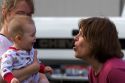 Woman sticking her tongue out at a baby to make it laugh.