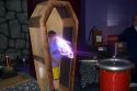 A boy in a wire cage demonstrating a Tesla coil with lightning at the Discovery Center in Little Rock, Arkansas.
