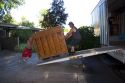 Movers push a piano up a ramp into the moving truck in Boise, Idaho.