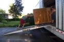 Movers push a piano up a ramp into the moving truck in Boise, Idaho.