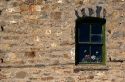 Rock building with window and flowers at Arco, Idaho.