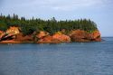 People sea kayaking in the Bay of Fundy at St. Martins, New Brunswick, Canada.
