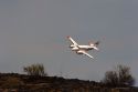 Twin engine aircraft used to guide fire retardant tankers during wildfire in Idaho.