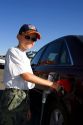 A nine year old boy pumps gasoline into a car at a gas station in Boise, Idaho. MR